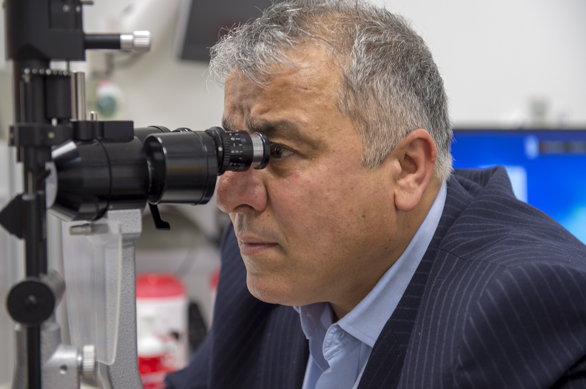 Optometrist checking patient's eyes.