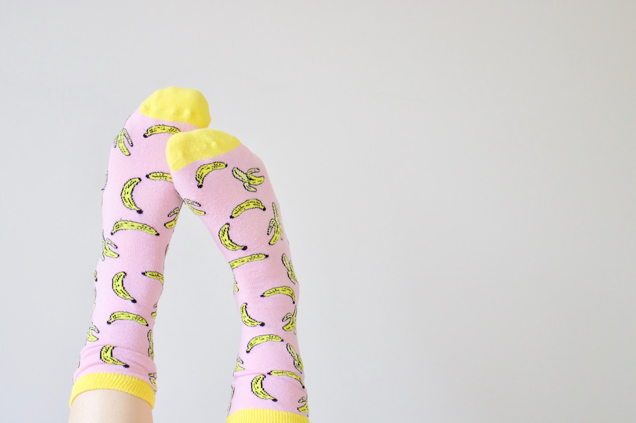 Pink and yellow socks with bananas all over them