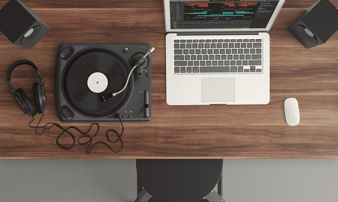 Overhead shot of a laptop and a turntable