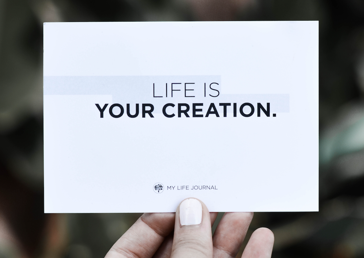Hand holding a business card that says