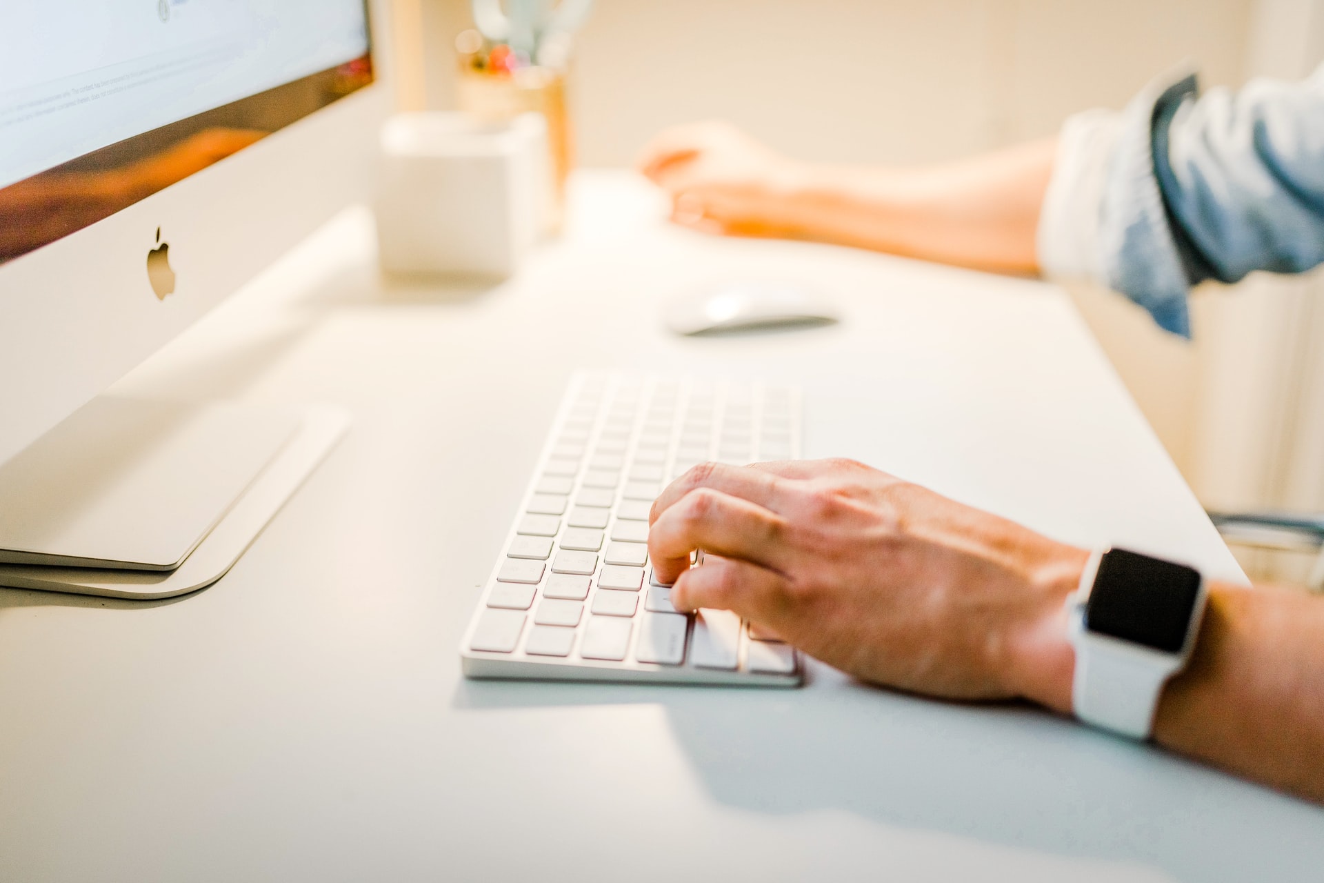 Person sitting at a mac typing