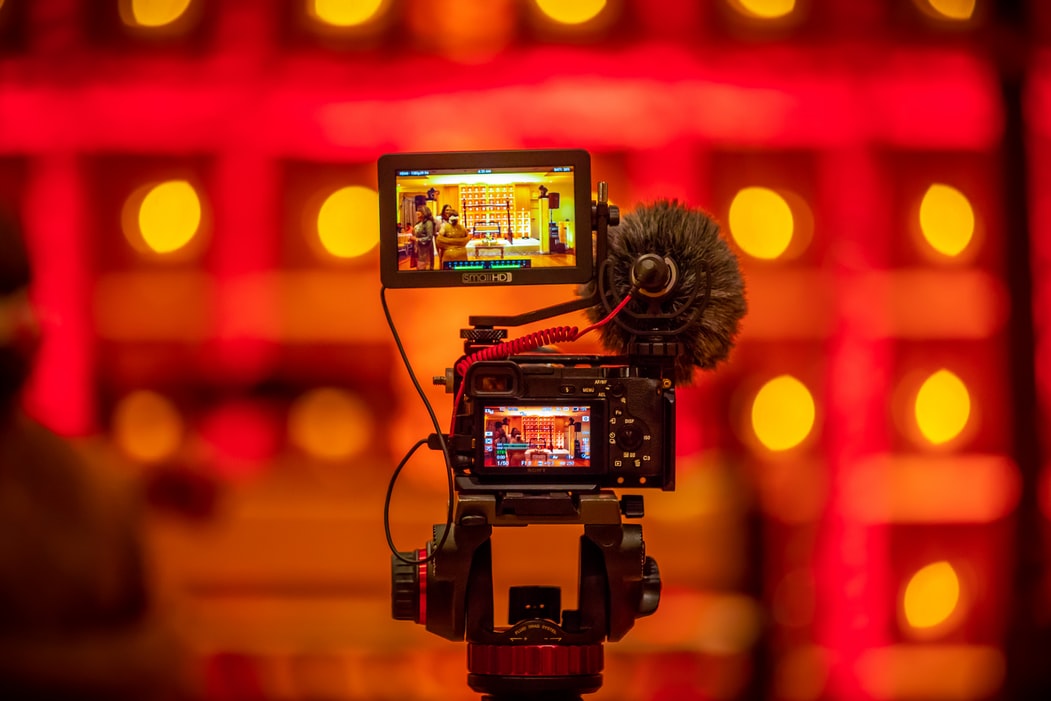 Camera filming with a boom