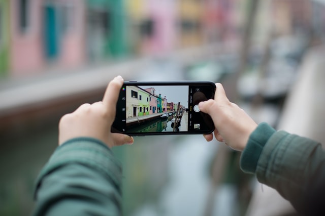 person taking horizontal pic of dock