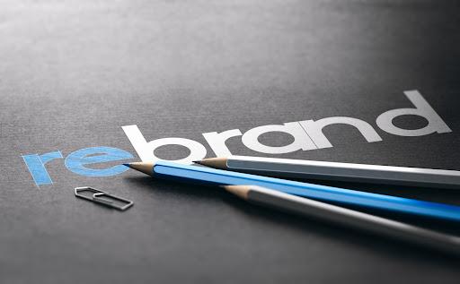 Word rebrand with the prefix re handwritten over black paper background, Marketing and brand management concept. 3D illustration