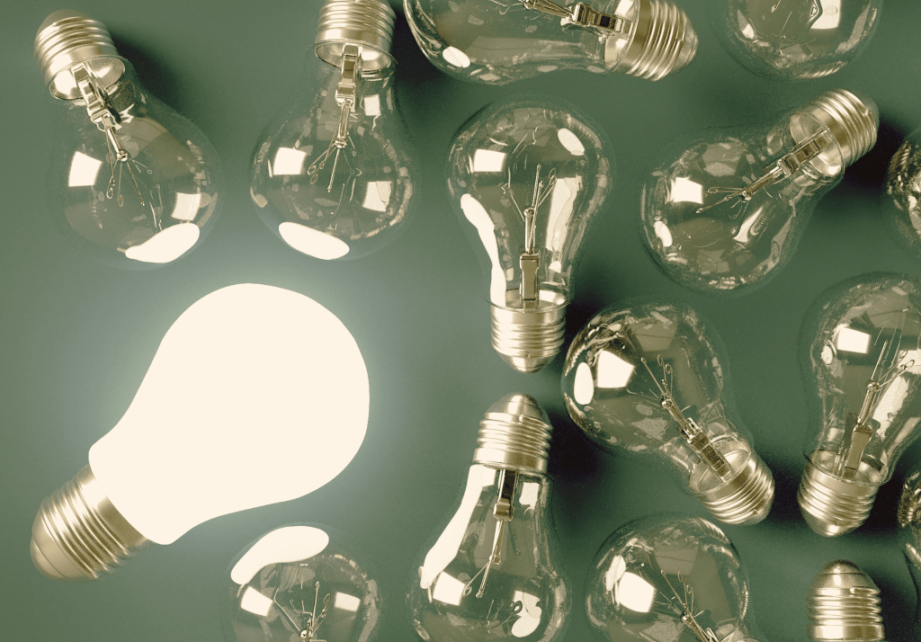 several lightbulbs, one bigger and lit up
